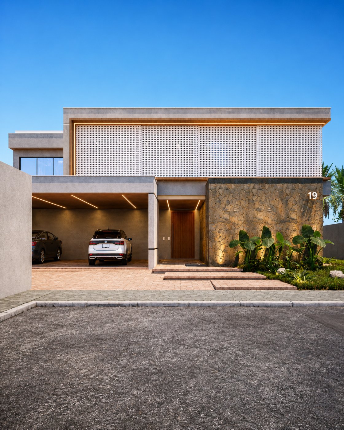Fachada frontal da Casa Raia com garagem, porta de madeira e parede de pedra iluminada